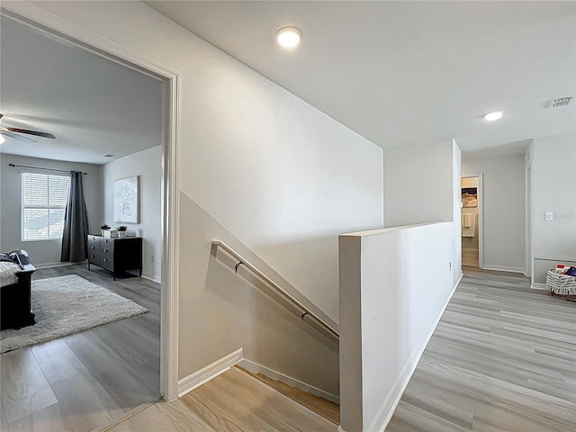 3279 Landing Vw, Tavares, FL 32778 - hallway featuring visible vents, baseboards, an upstairs landing, and wood finished floors