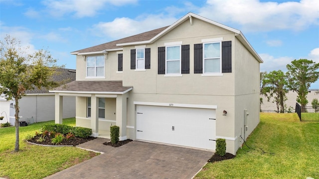 3279 Landing Vw, Tavares, FL 32778 - traditional-style home featuring a garage, stucco siding, decorative driveway, a front lawn, and a shingled roof