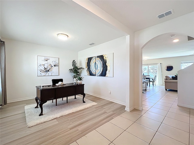 3279 Landing Vw, Tavares, FL 32778 - office space featuring light wood-style floors, arched walkways, visible vents, and baseboards