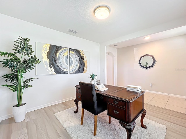 3279 Landing Vw, Tavares, FL 32778 - office featuring light wood-type flooring, baseboards, visible vents, and arched walkways