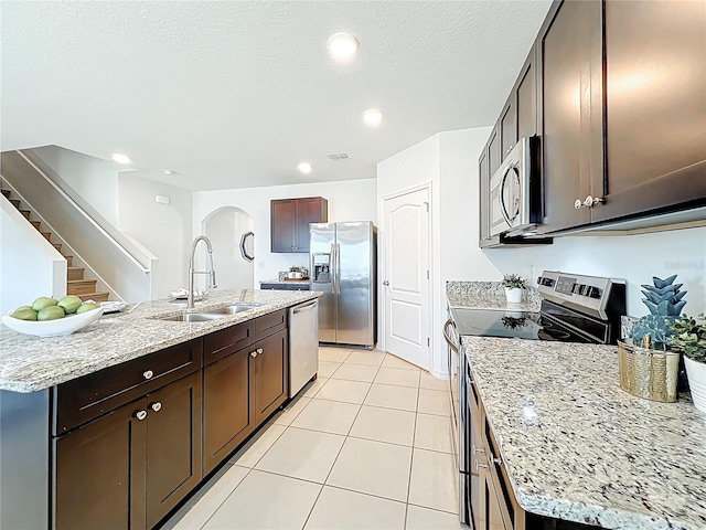 3279 Landing Vw, Tavares, FL 32778 - kitchen featuring light tile patterned floors, dark brown cabinets, visible vents, stainless steel appliances, and a sink