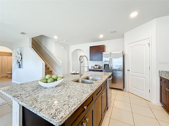 3279 Landing Vw, Tavares, FL 32778 - kitchen featuring arched walkways, a sink, visible vents, and stainless steel appliances
