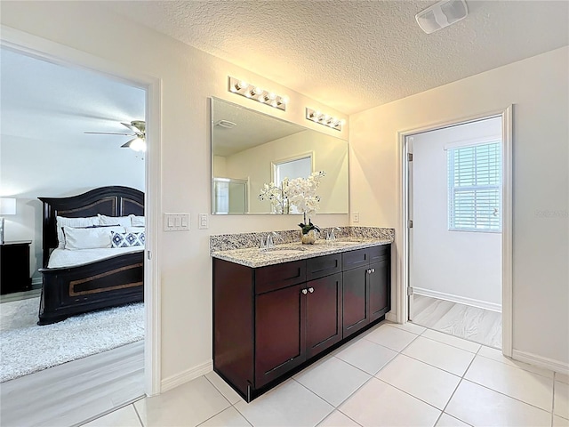 3279 Landing Vw, Tavares, FL 32778 - full bath with baseboards, double vanity, connected bathroom, visible vents, and a sink