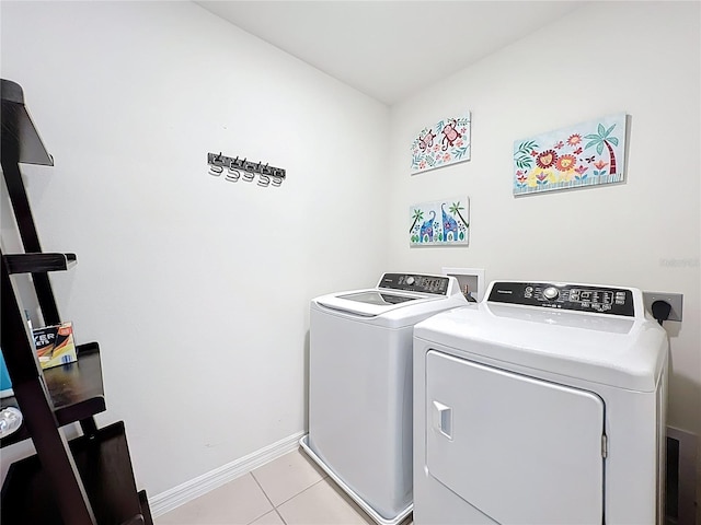 3279 Landing Vw, Tavares, FL 32778 - laundry area featuring independent washer and dryer, laundry area, baseboards, and light tile patterned flooring