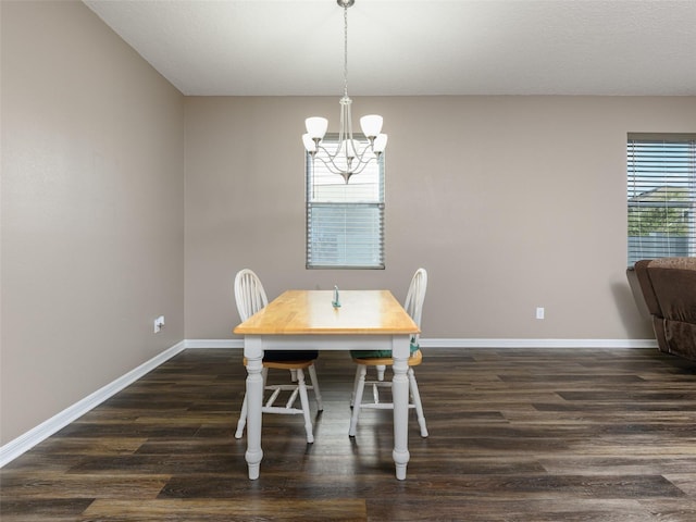 dining area with a chandelier, baseboards, and dark wood finished floors