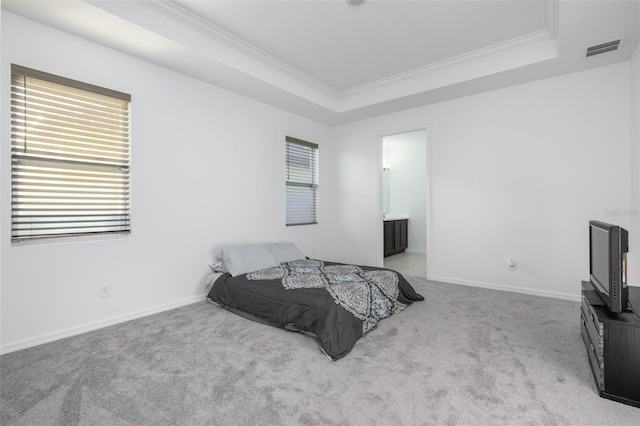 bedroom with a tray ceiling, visible vents, and carpet flooring