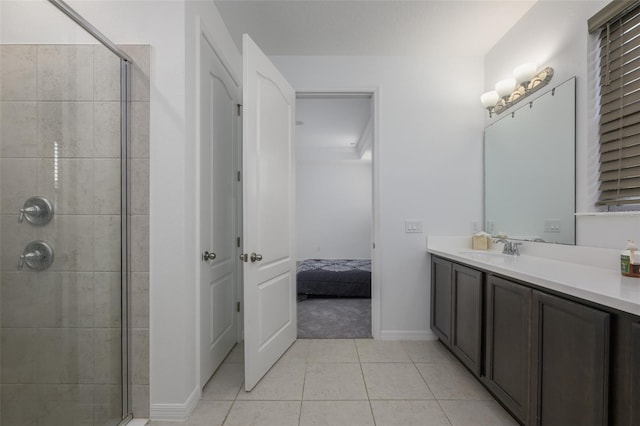 ensuite bathroom with vanity, ensuite bath, tile patterned floors, and tiled shower