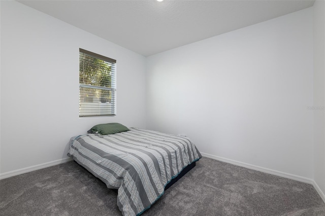 bedroom with carpet flooring and baseboards