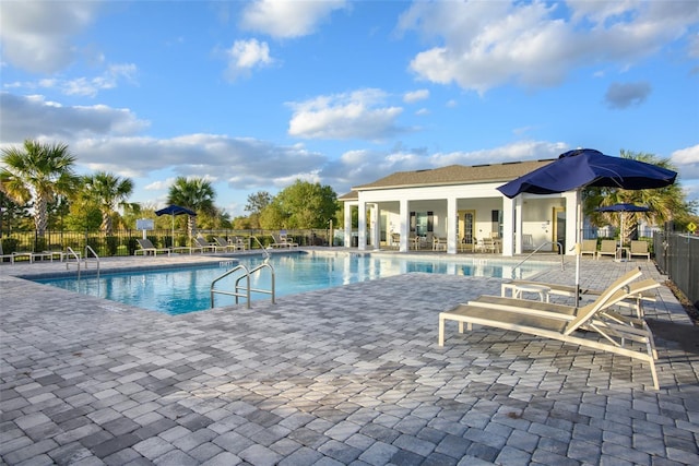 community pool featuring a patio and fence