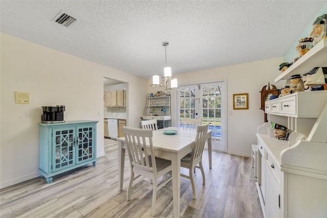 dining space with visible vents, a textured ceiling, french doors, light wood-style floors, and baseboards