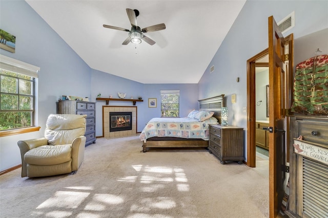 bedroom with visible vents, high vaulted ceiling, carpet, baseboards, and a tile fireplace