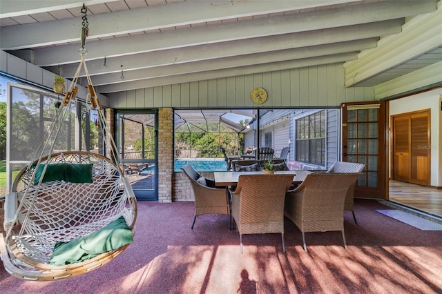 sunroom with lofted ceiling with beams