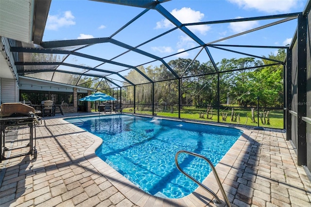 outdoor pool featuring glass enclosure, a patio, and a grill