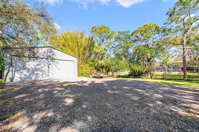 view of yard with a garage and an outdoor structure