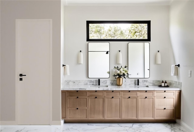 full bathroom featuring marble finish floor, vanity, and baseboards