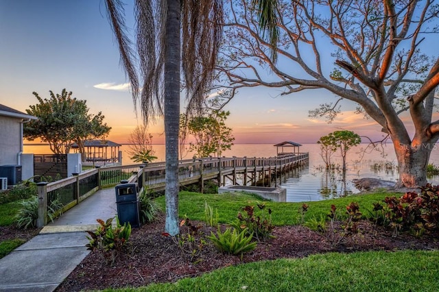 view of dock with a water view and central AC unit