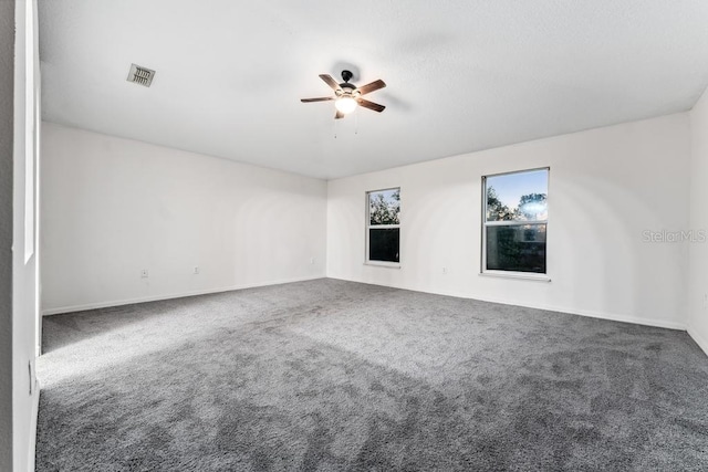 unfurnished room featuring visible vents, a ceiling fan, and carpet flooring