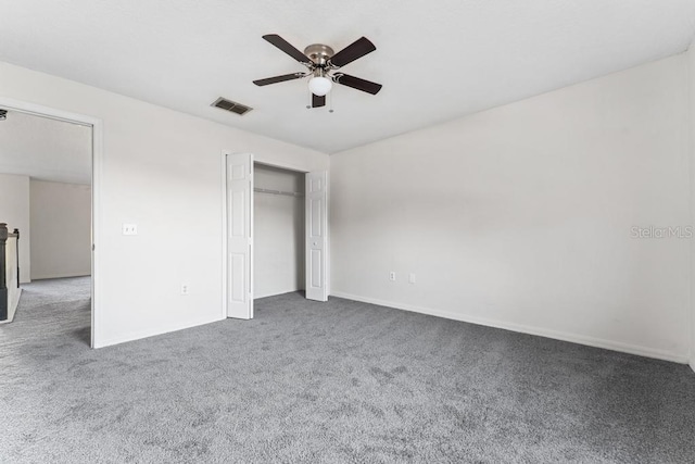 unfurnished bedroom featuring a ceiling fan, carpet, visible vents, and a closet