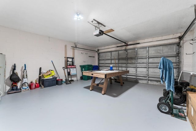 garage featuring concrete block wall and a garage door opener