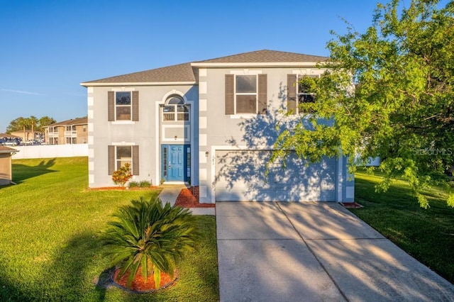 view of front of house with stucco siding, a garage, concrete driveway, and a front lawn