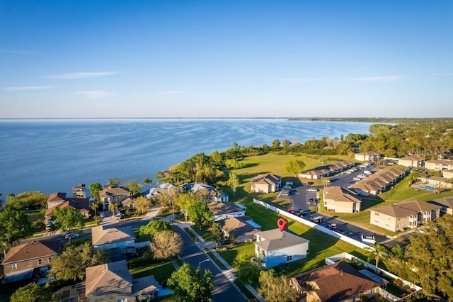 drone / aerial view featuring a residential view and a water view