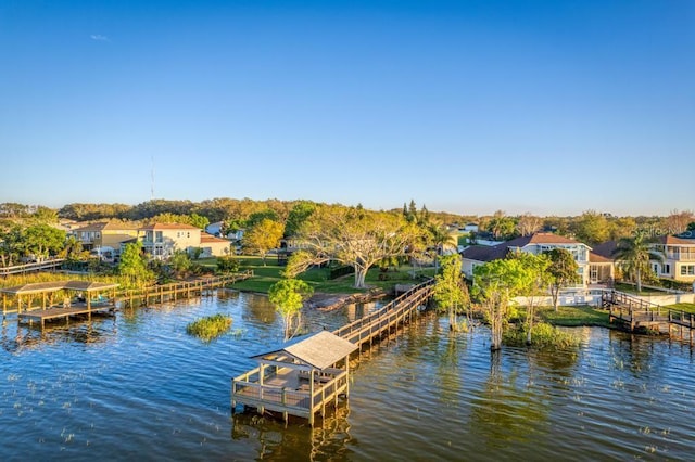 view of dock featuring a residential view and a water view