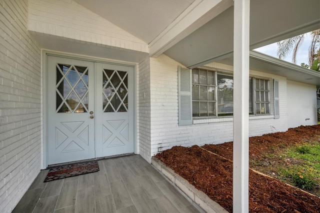 property entrance featuring brick siding