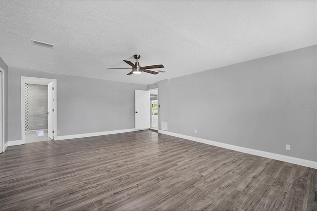 unfurnished room with visible vents, baseboards, ceiling fan, and wood finished floors