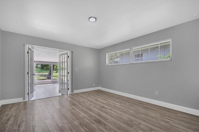 empty room featuring wood finished floors and baseboards