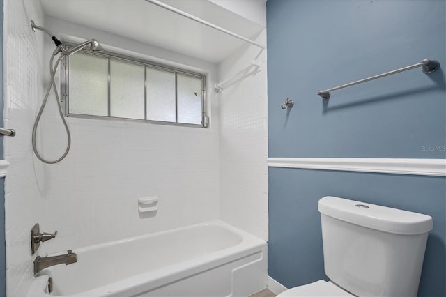 bathroom featuring shower / bathing tub combination and toilet