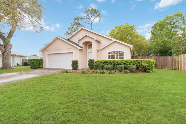 view of front of house with stucco siding, driveway, fence, a front yard, and a garage