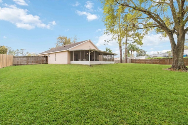 view of yard with a fenced backyard and a sunroom