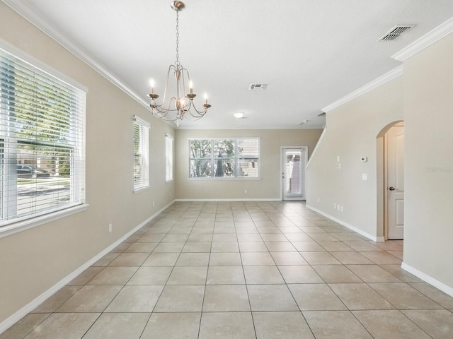 spare room featuring arched walkways, visible vents, a chandelier, and crown molding