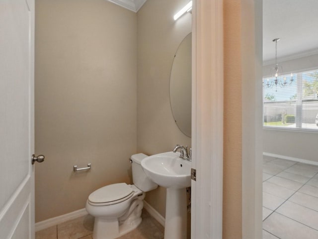 half bath featuring tile patterned floors, baseboards, toilet, and crown molding