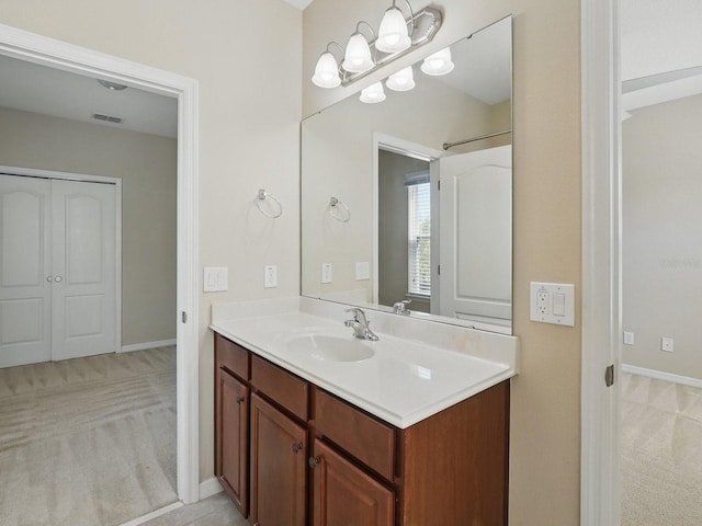 bathroom with visible vents, baseboards, and vanity