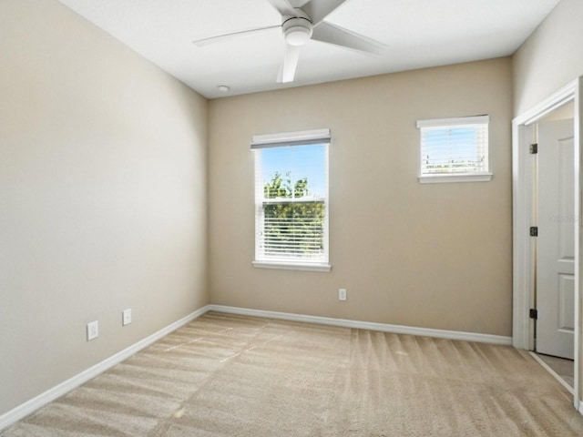 unfurnished room with light carpet, plenty of natural light, and ceiling fan