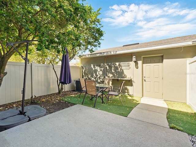 view of patio / terrace featuring fence