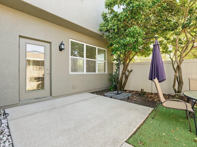 view of patio featuring fence