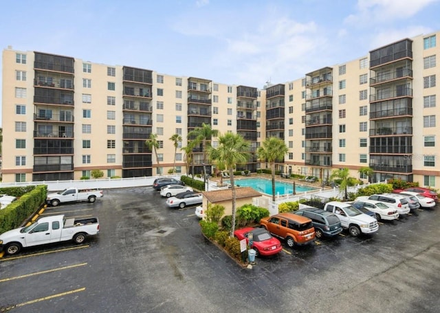 view of building exterior with uncovered parking