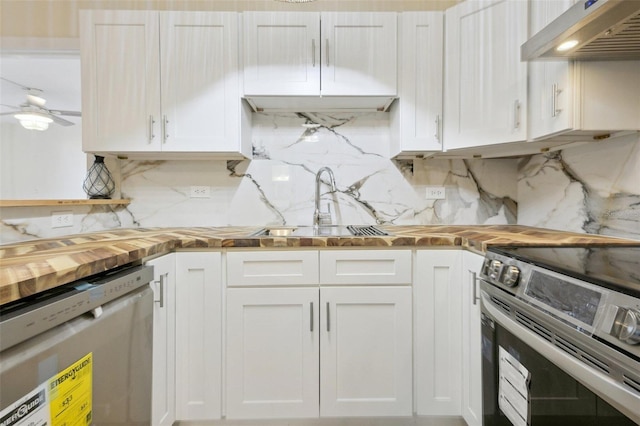 kitchen with under cabinet range hood, stainless steel electric stove, dishwasher, white cabinetry, and wood counters