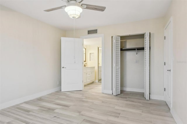 unfurnished bedroom with light wood-style flooring, baseboards, visible vents, and a closet