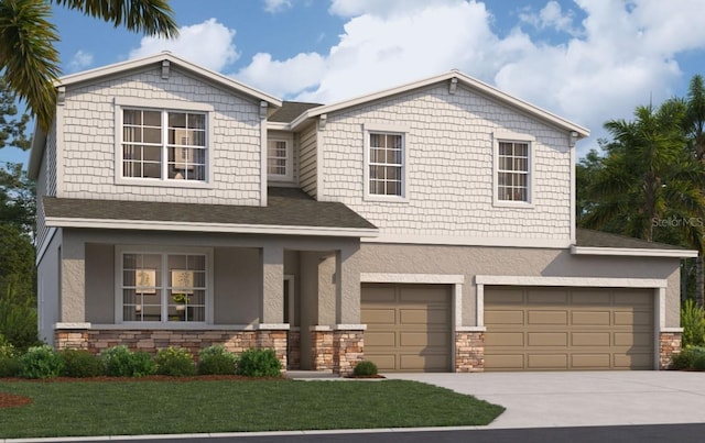 craftsman inspired home featuring concrete driveway, a front yard, stucco siding, a garage, and stone siding