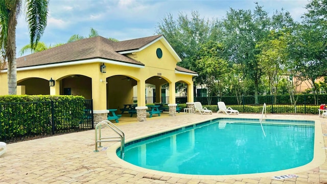 pool featuring a patio and fence