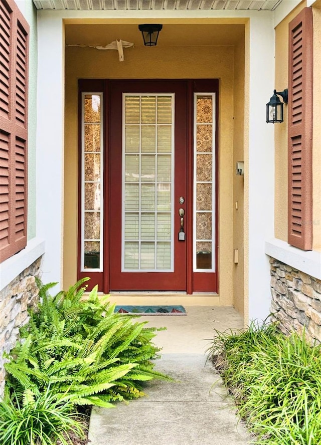 property entrance with stucco siding