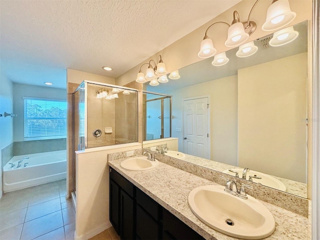 bathroom with a shower stall, a textured ceiling, and a sink