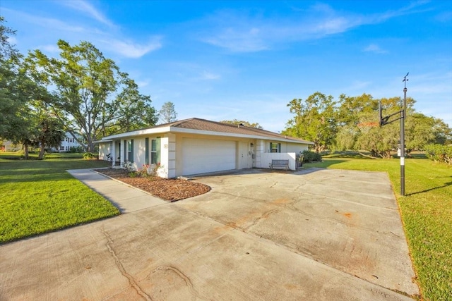 view of front of property with a garage, driveway, a front yard, and stucco siding