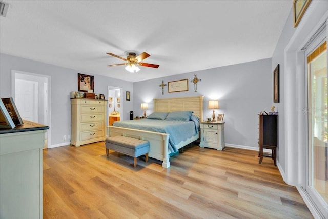 bedroom featuring visible vents, baseboards, light wood finished floors, ceiling fan, and ensuite bathroom