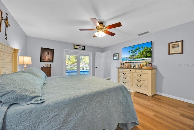 bedroom with visible vents, a ceiling fan, access to outside, wood finished floors, and baseboards