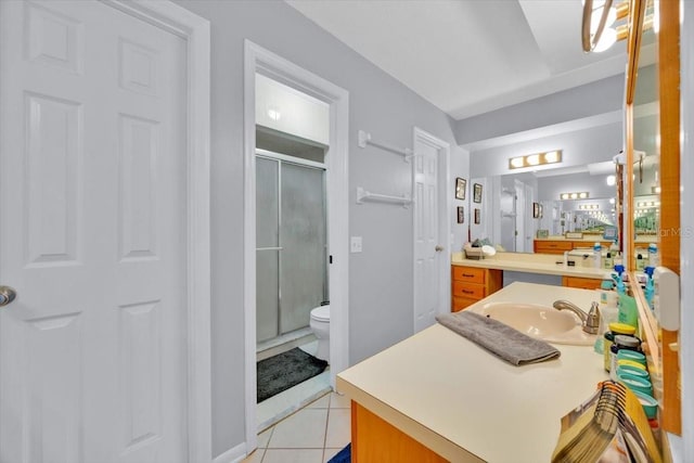 full bathroom featuring tile patterned floors, toilet, a stall shower, and vanity