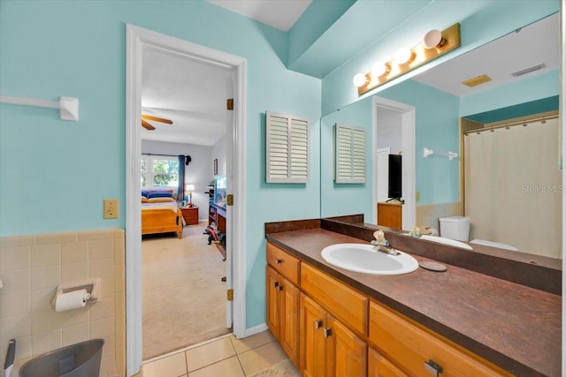 ensuite bathroom with visible vents, toilet, connected bathroom, tile patterned flooring, and vanity